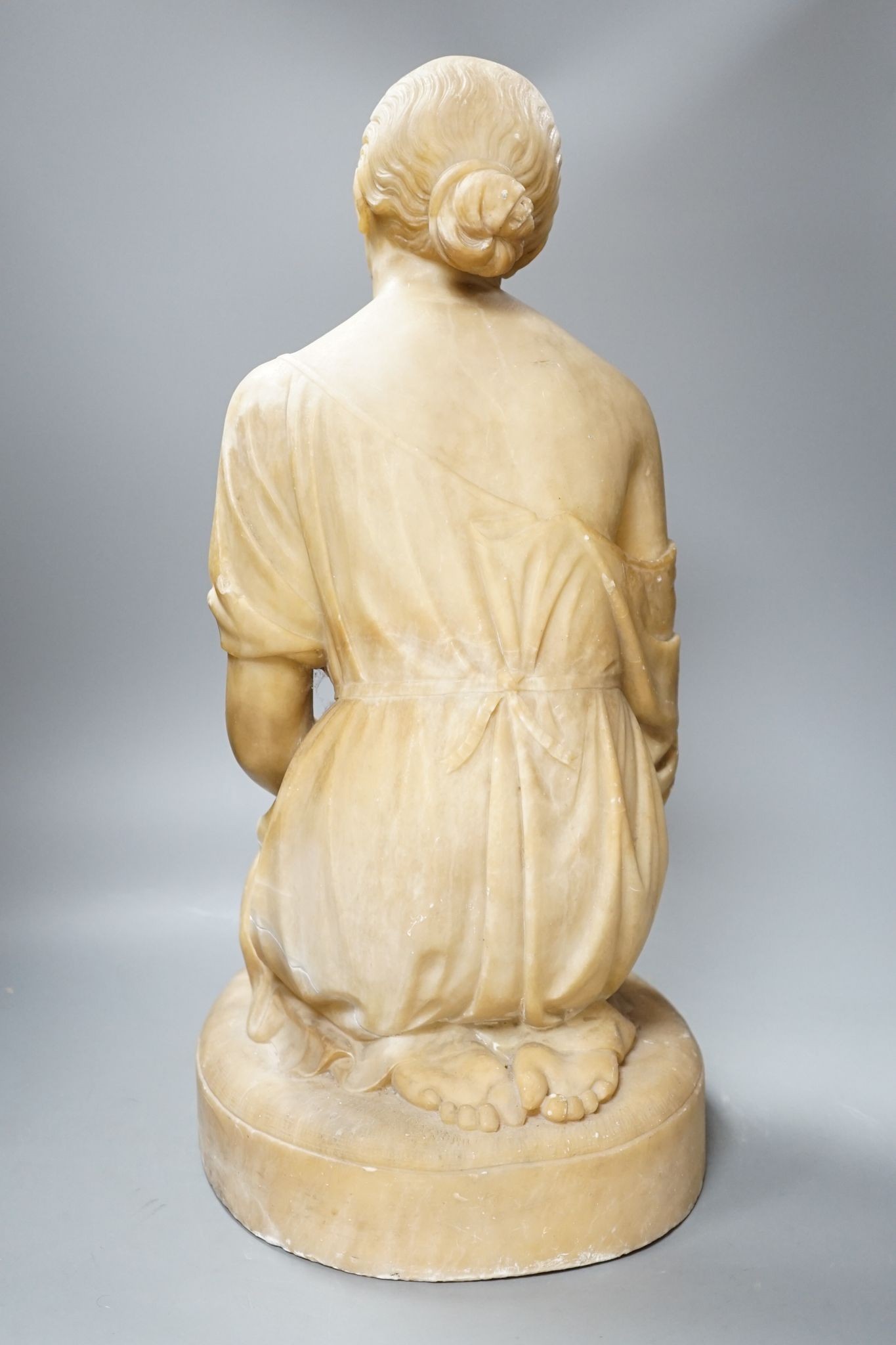 A Victorian alabaster figure kneeling female, 51cm
